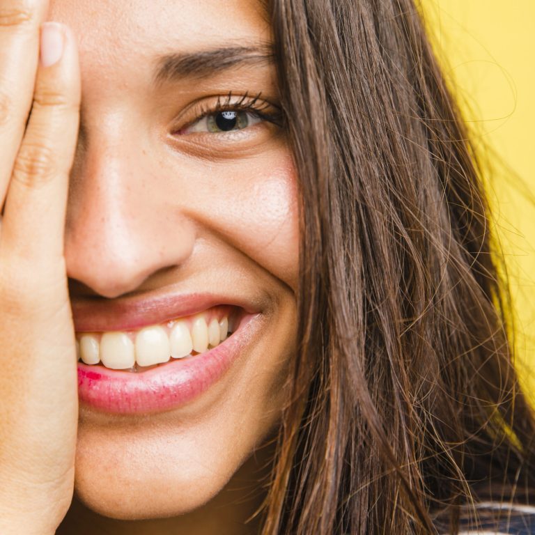 woman patient smiles in the photo after gum aesthetics