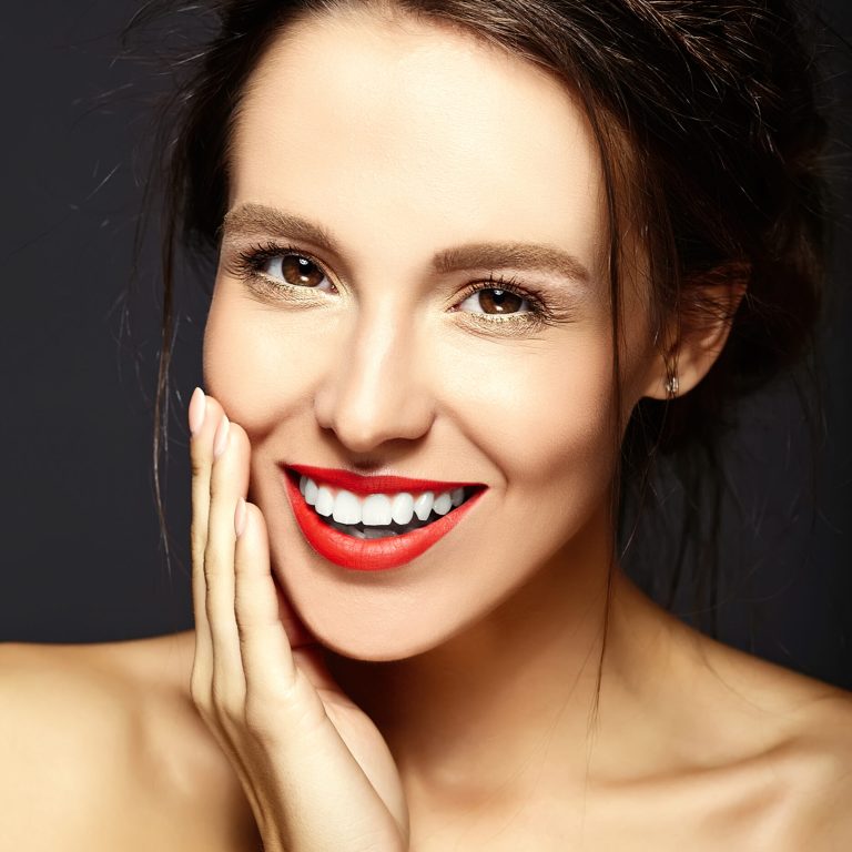 woman patient shows her smile after porcelain veneers