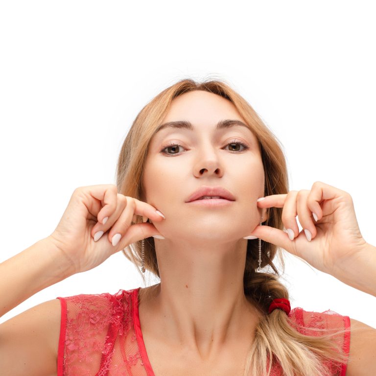 woman shows her facein the photo after facial liposuction