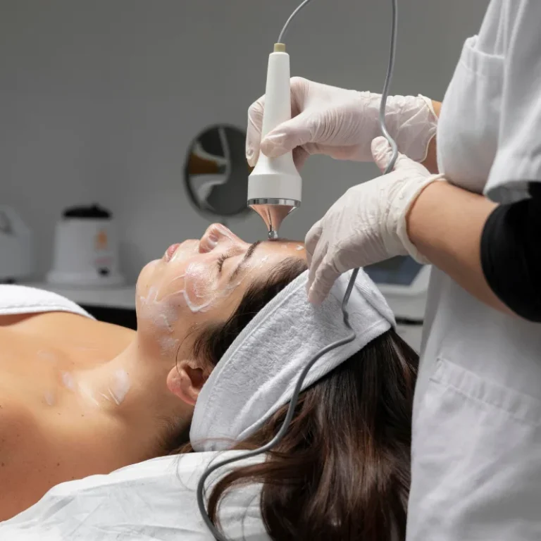 an expert performs chemical peels to her patient in the photo